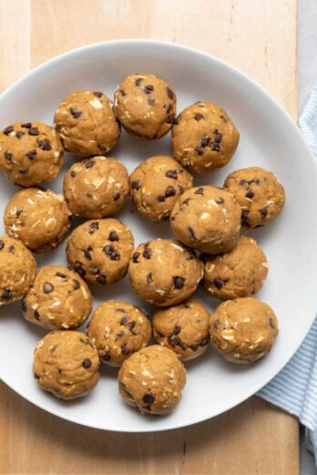 Bowl of no bake pumpkin balls with chocolate chips