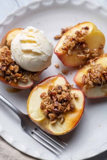 Cinnamon Baked Apples with Oats & Pecans mixture on top and scoop of vanilla ice cream