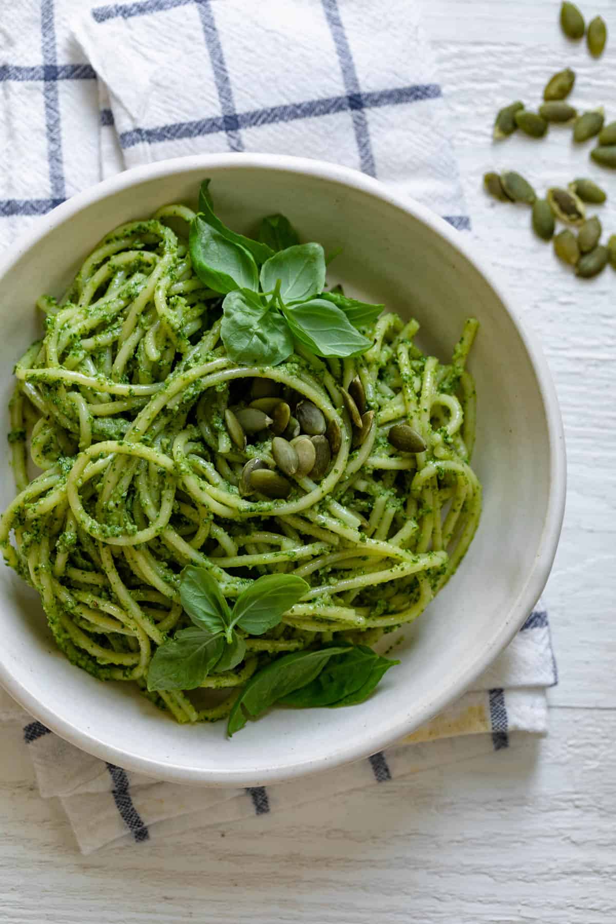 Pumpkin Seed Pesto Pasta in a white bowl wit a fork