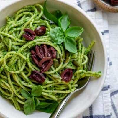 Pumpkin seed pesto pasta topped with kalamata olives