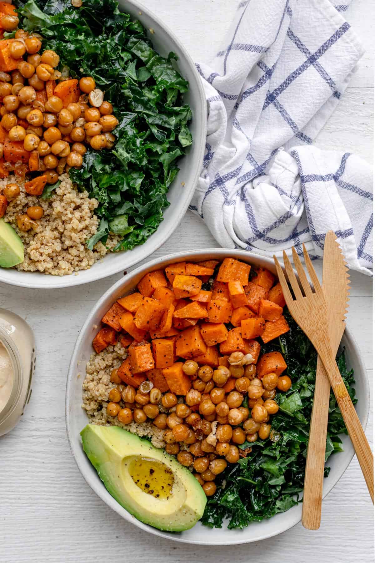 Two vegan buddah bowls made with quinoa, sweet potatoes and kale