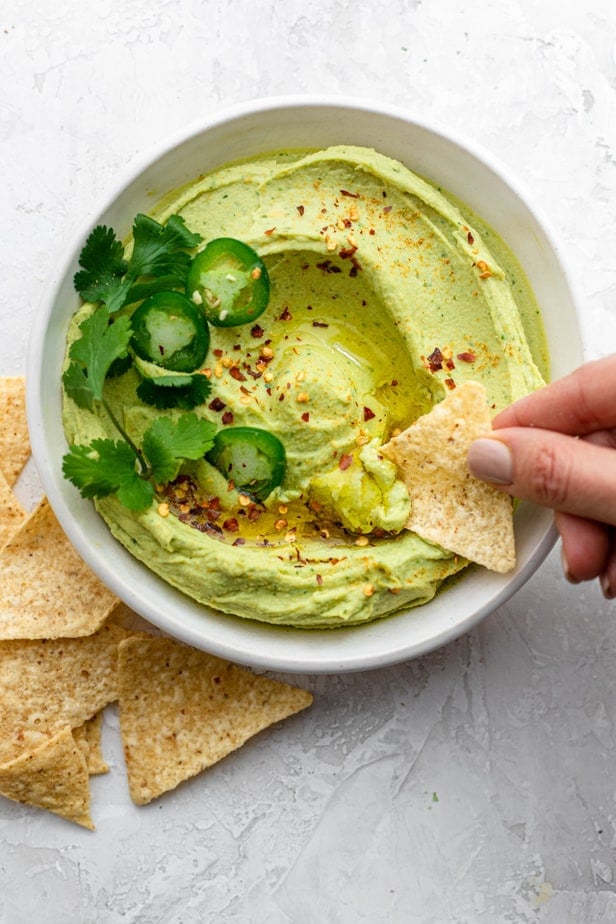 Dipping chips in the avocado dip