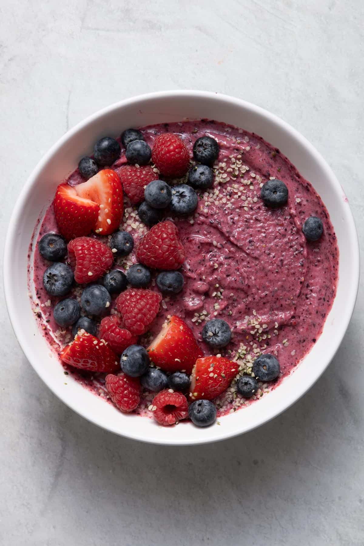 Strawberry blueberry smoothie bowl topped with berries
