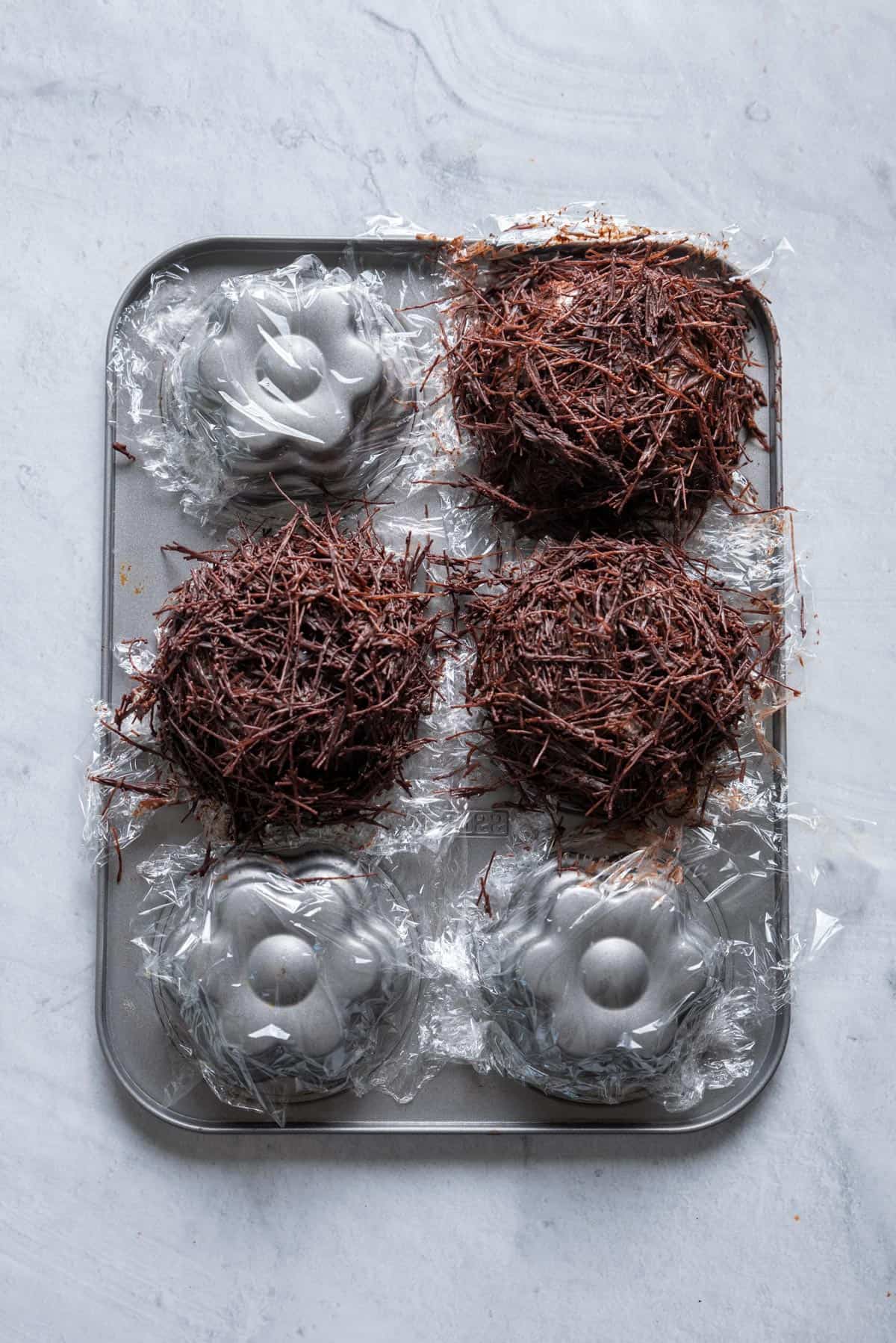 Forming the chocolate nests around the muffin tins