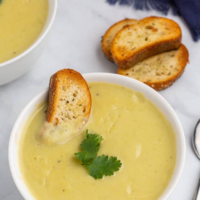 This healthy potato leek soup is a simple classic recipe that's made with potatoes, leeks, garlic and vegetable broth. For healthy swaps, I use olive oil instead of butter, use sour cream instead of heavy cream and skip the flour. It makes a smooth, creamy and velvety soup that's nourishing for your body and soul!