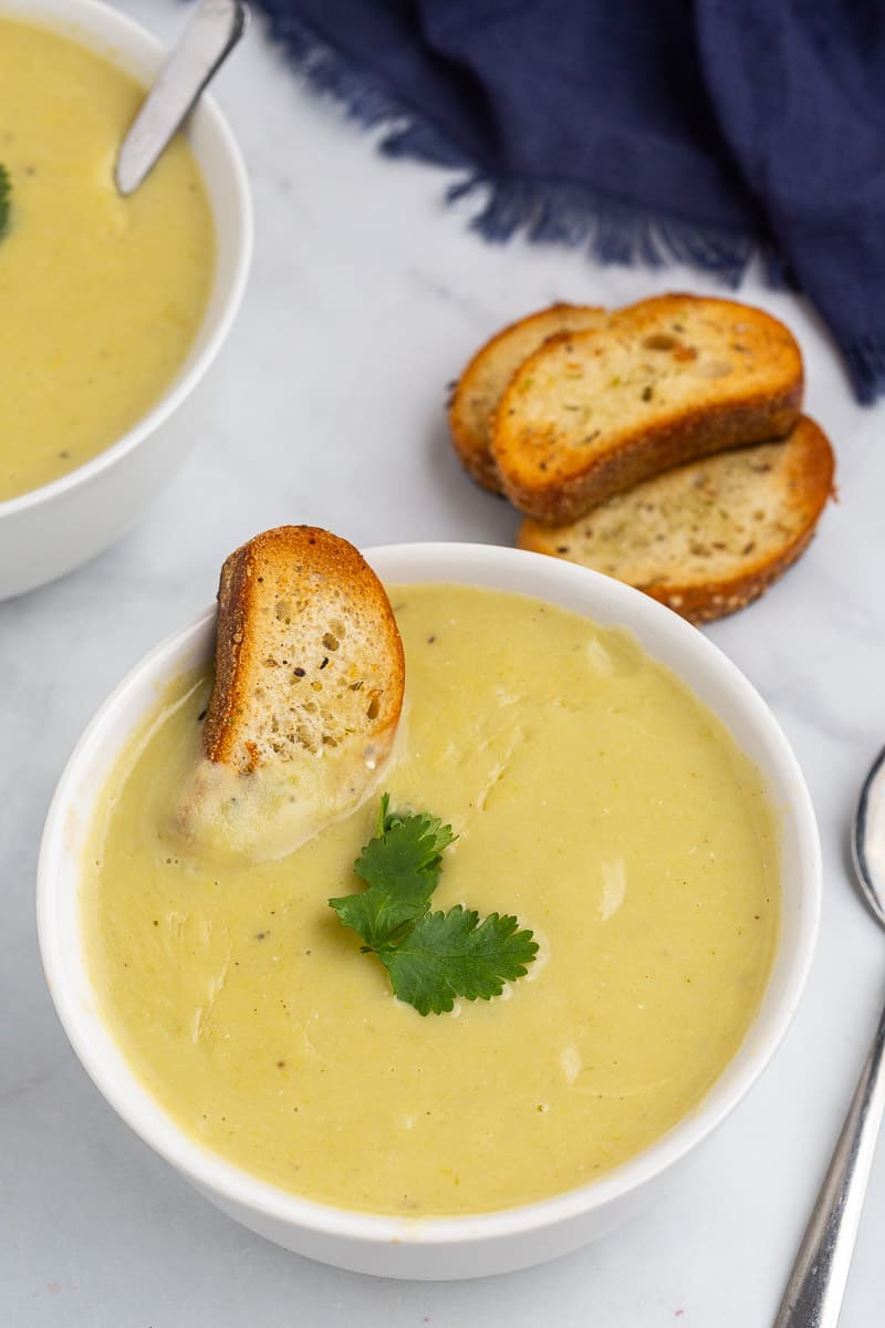 This healthy potato leek soup is a simple classic recipe that's made with potatoes, leeks, garlic and vegetable broth. For healthy swaps, I use olive oil instead of butter, use sour cream instead of heavy cream and skip the flour. It makes a smooth, creamy and velvety soup that's nourishing for your body and soul!