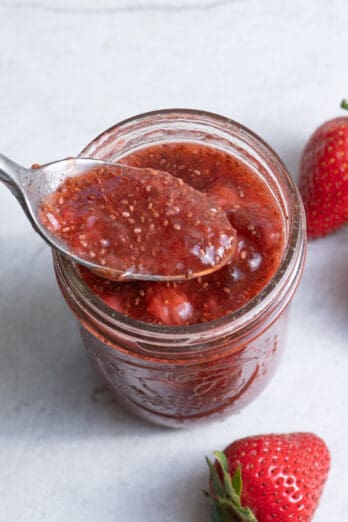 Spoon inside jar of strawberry chia jam