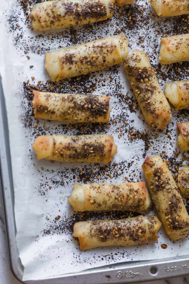 Zaatar spring rolls fresh from the oven on a baking dish with parchment paper.