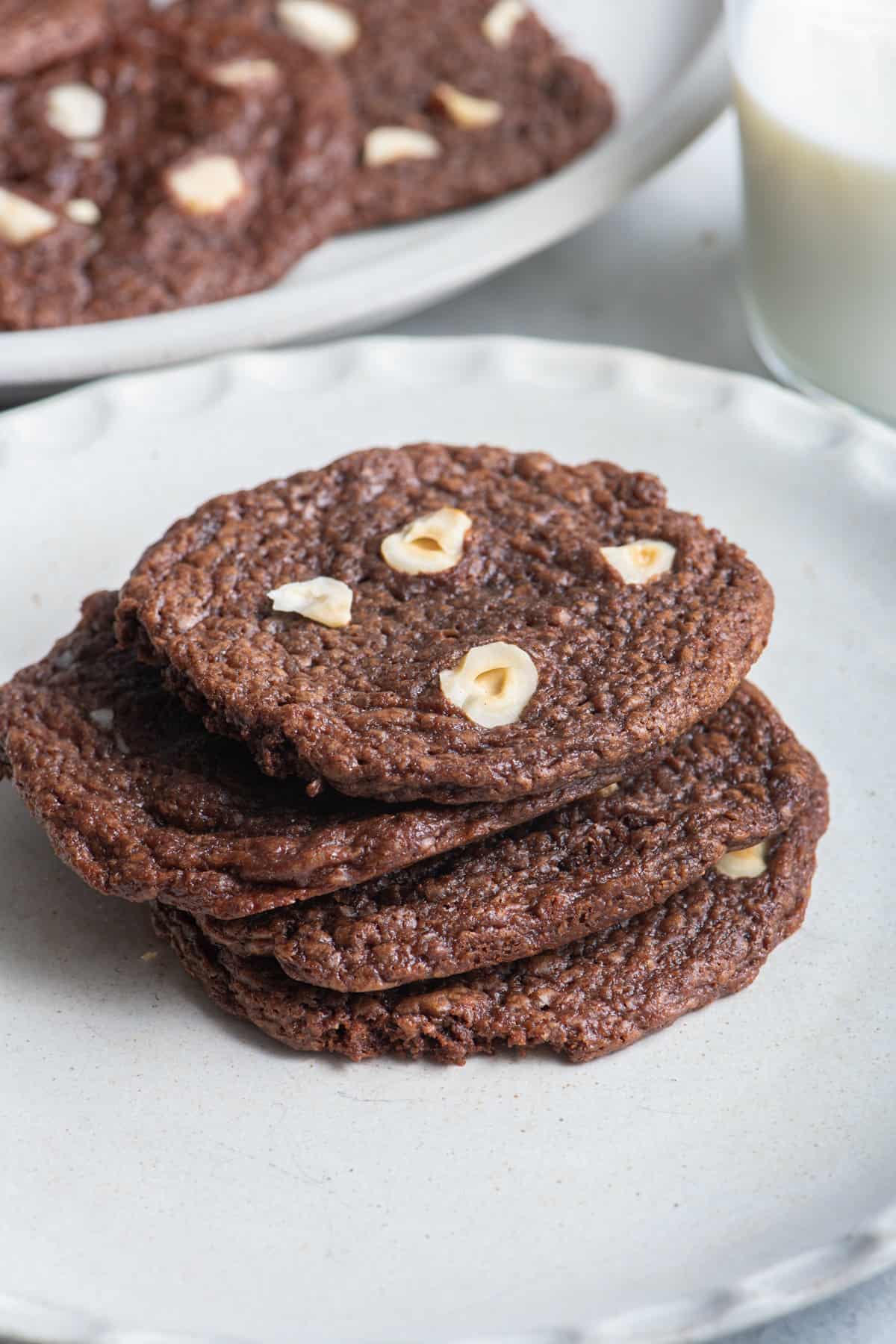 Chocolate hazelnut cookies stacked on a plate