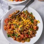 Two bowls of the unstuffed peppers recipes topped with cheese