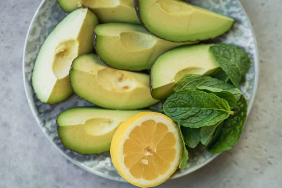 The ingredients needed to make avocado ice cream, in a large bowl.