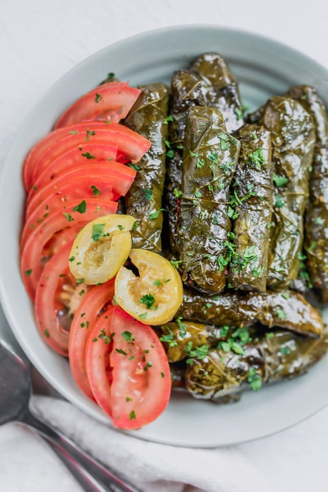 These Vegetarian Stuffed Grape Leaves with sliced tomatoes