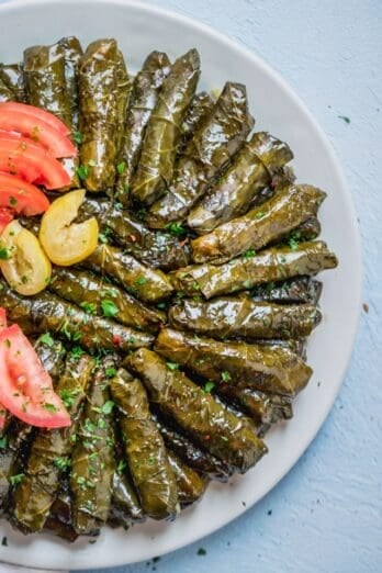 Large plate of rolled vegetarian stuffed grape leaves