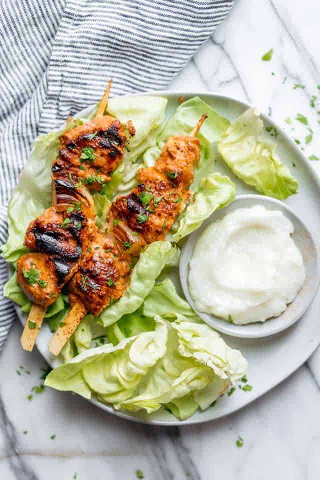 Shish Tawook is a popular Lebanese grilled chicken skewers recipe. It's tender juicy chicken marinated in yogurt, lemon & garlic and served with pita bread