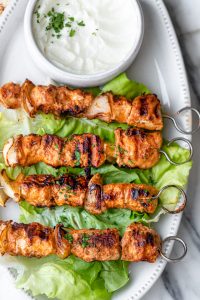 Shish tawook recipe on a platter with garlic sauce