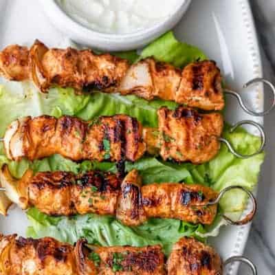 Shish tawook recipe on a platter with garlic sauce