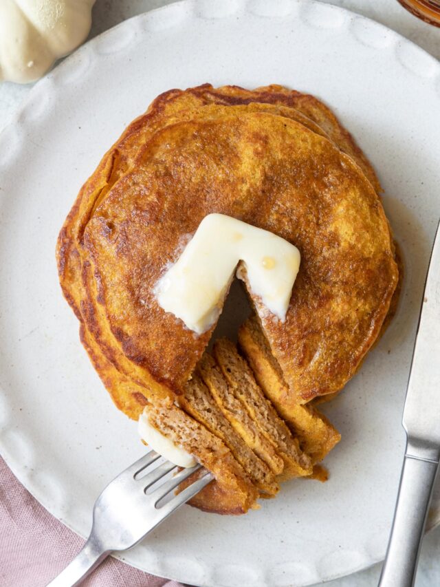 Close-up angle of the healthy pumpkin pancakes with a fork on a bite of pancakes