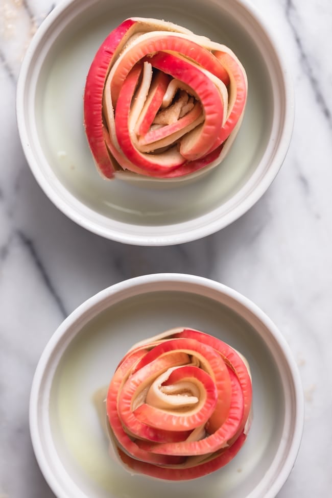 Rose Apple Pies in a ramekin ready to be baked in the oven.