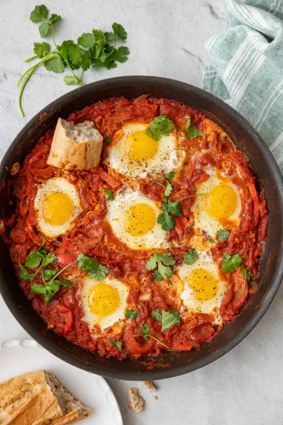 Final poached eggs Shakshuka Recipe in a stainless steel pan