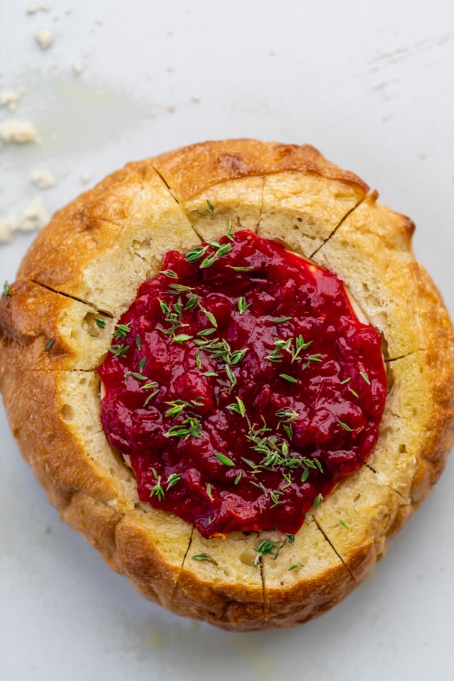 Brie with cranberry in bread bowl before baking