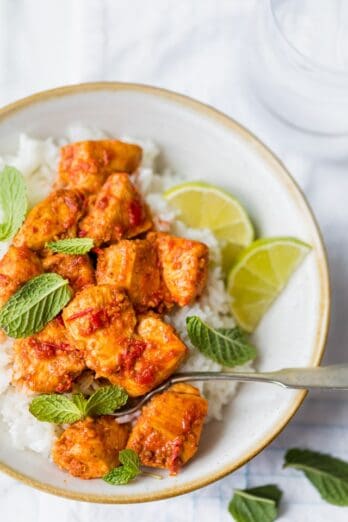 Close up of harissa chicken in a bowl with rice