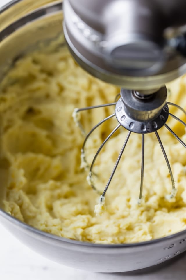 Healthy mashed potatoes getting whipped in an electric mixer