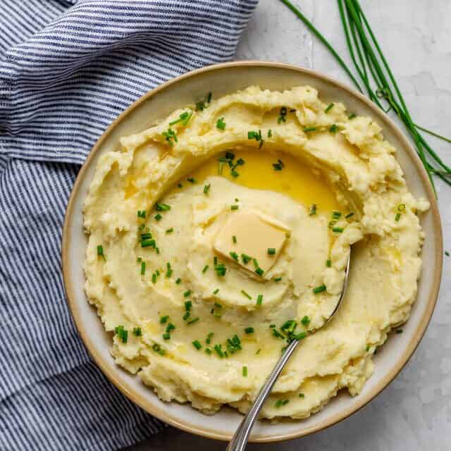 Final plate of healthy mashed potatoes served with fresh chives and a dab of butter