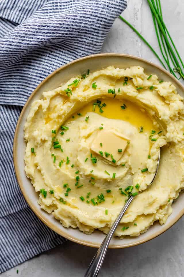 Final plate of healthy mashed potatoes served with fresh chives and a dab of butter