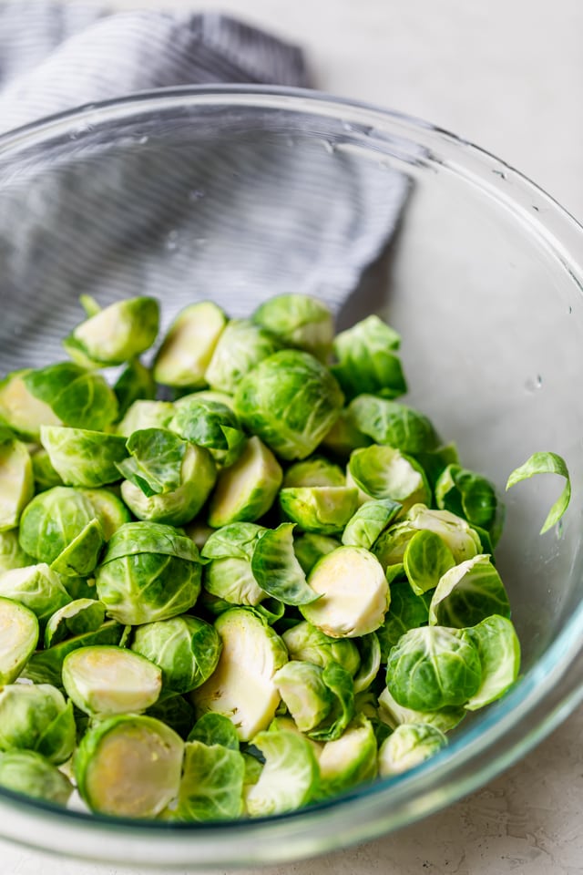 Bowl of raw brussel sprouts sliced in half