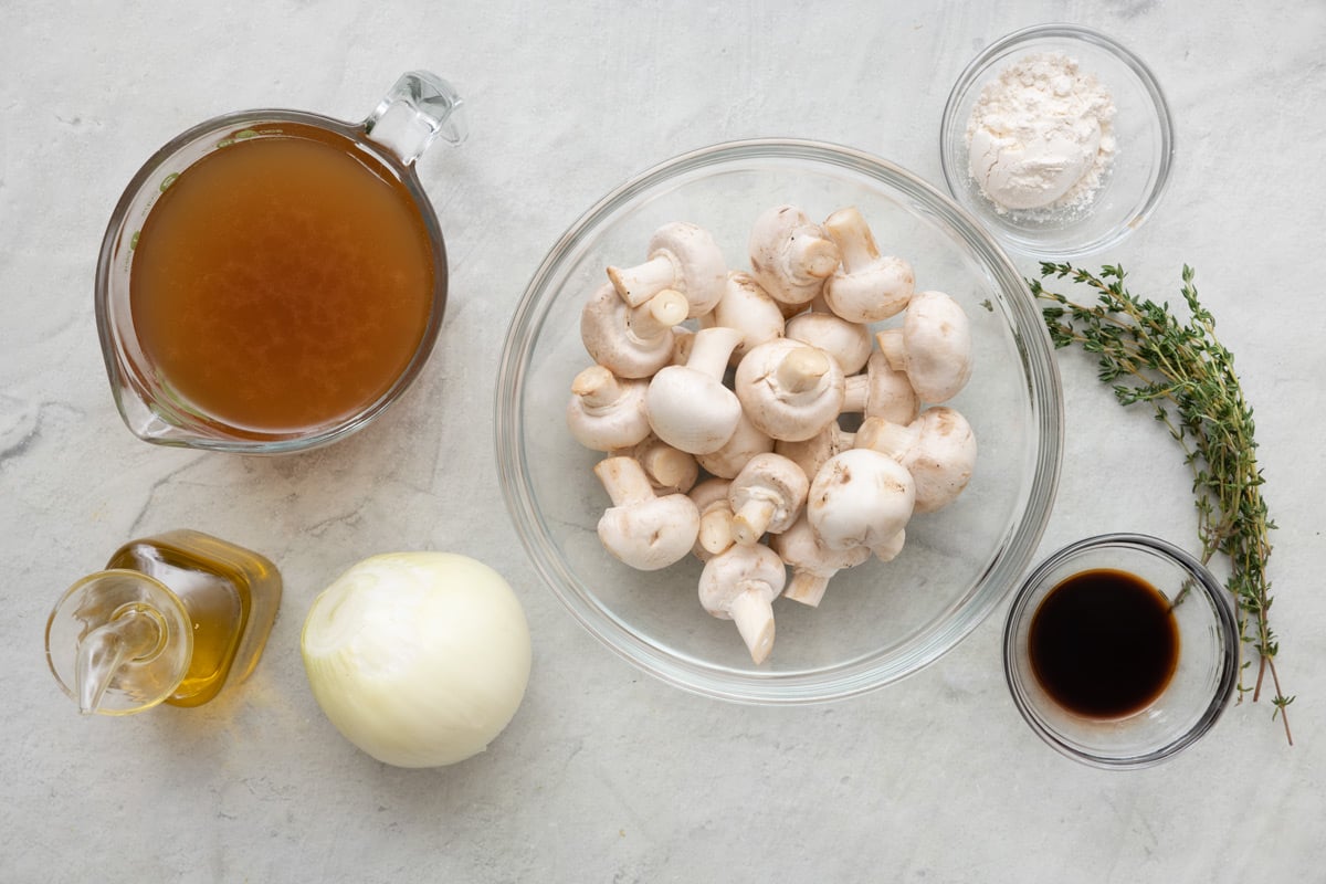 Ingredients for recipe before prepped: olive oil, soy sauce, vegetable broth, mushroom, onions, flour and thyme