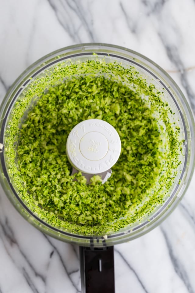 Broccoli getting grated in a food processor