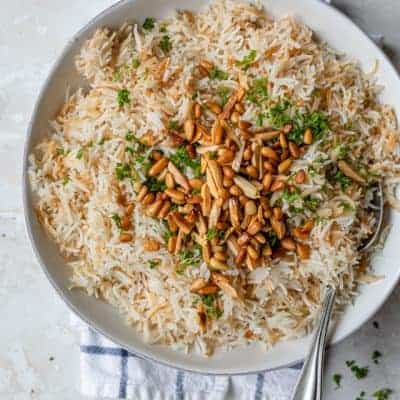 Plate served of Lebanese Rice topped with pine nuts, almonds and parsley