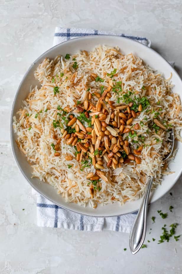 Plate served of Lebanese Rice topped with pine nuts, almonds and parsley