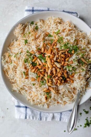 Plate served of Lebanese Rice topped with pine nuts, almonds and parsley