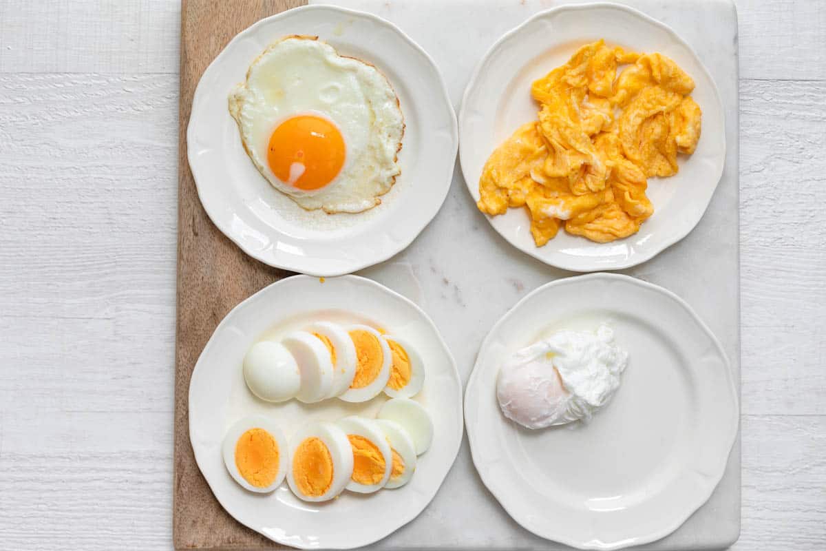 4 plates with 4 types of eggs for topping the toast