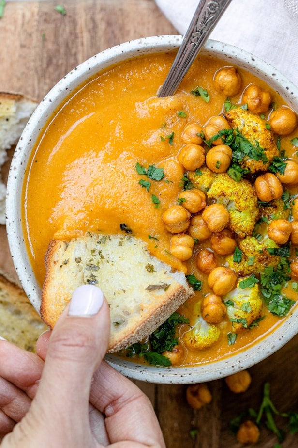 Dipping some bread into the Sweet potato cauliflower soup