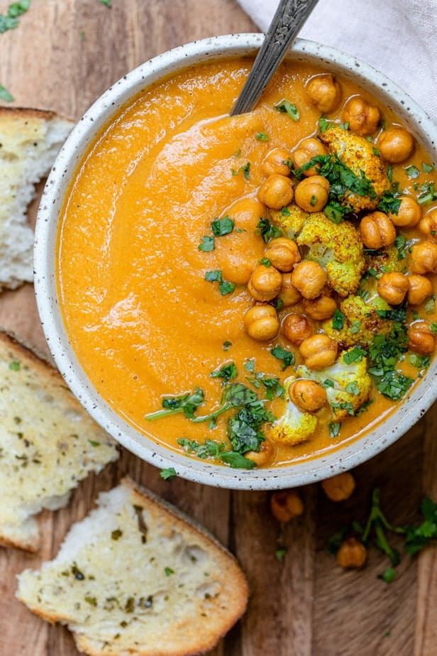 Sweet potato cauliflower soup in a bowl topped with roasted chickpeas