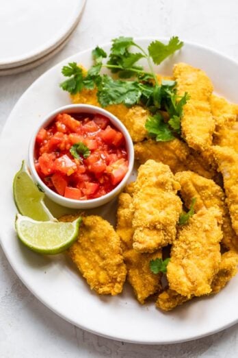 Final plated tortilla crusted chicken with salsa