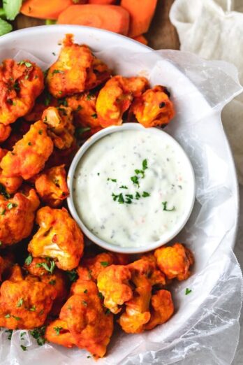 Large bowl of cauliflower buffalo bites with ranch dipping sauce