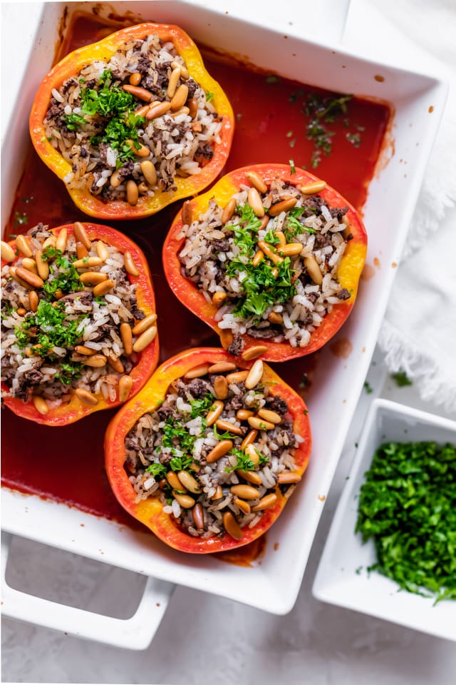 Completed stuffed peppers dish with parsley on the side