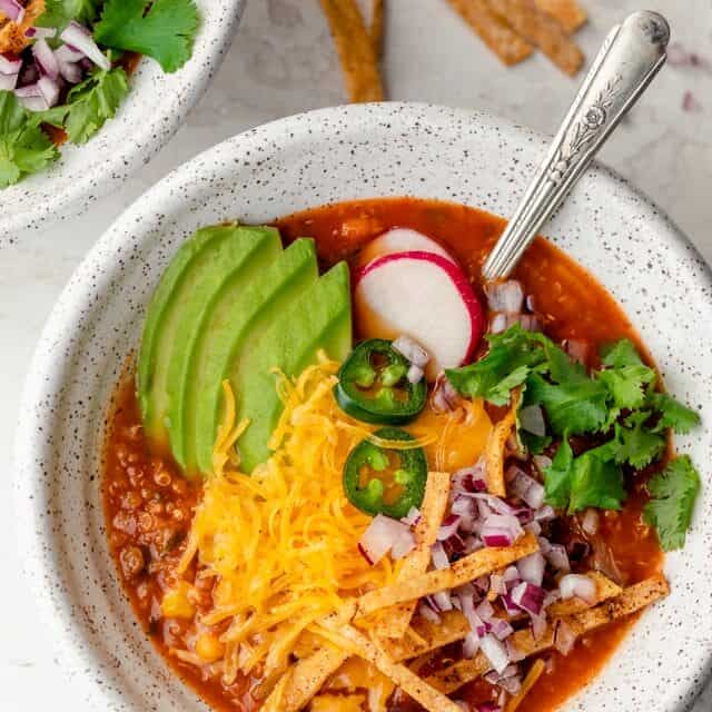 Close up shot of vegetarian tortilla soup with all the toppings