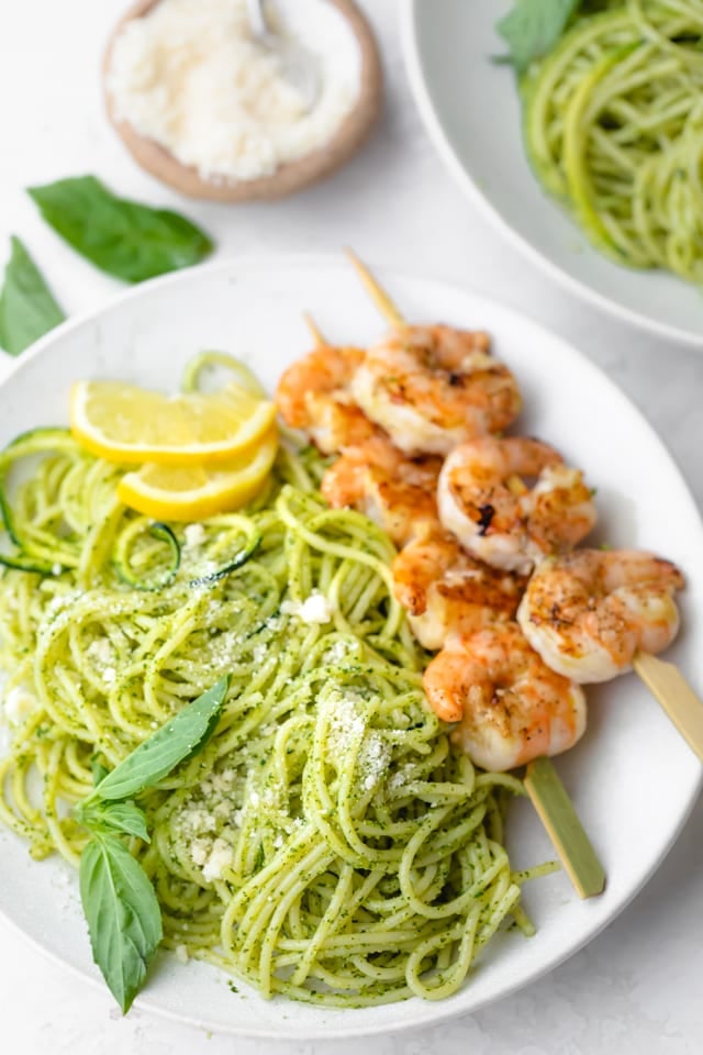 Close up of the pesto spaghetti with parmesan cheese on top