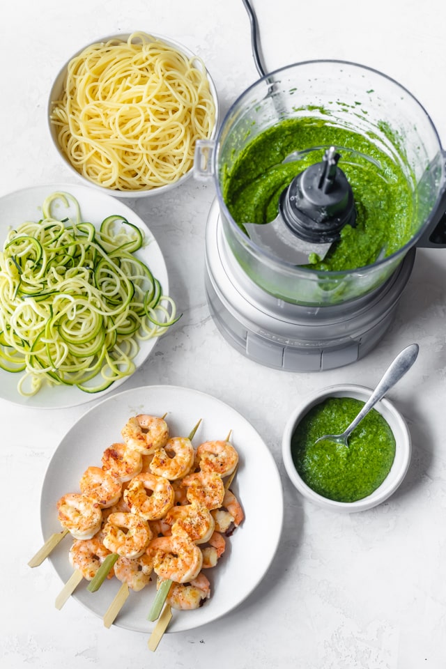 Pesto sauce in food processor, grilled shrimp, zoodles and spaghetti