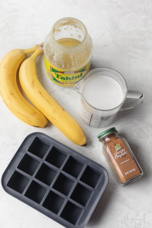 Ingredients to make recipe: bananas, tahini, almond milk, cinnamon and ice cube tray for freezing almond milk