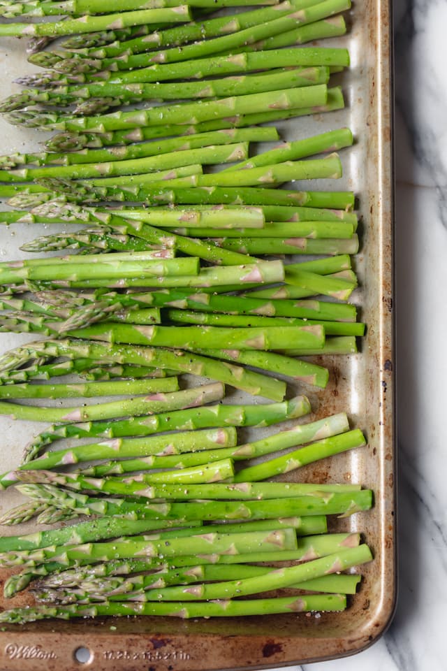 Asparagus on a baking sheet before getting roasted