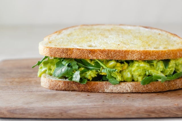 Straight on view of sandwich on a cutting board