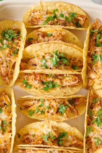 Baked chicken tacos in baking pan.
