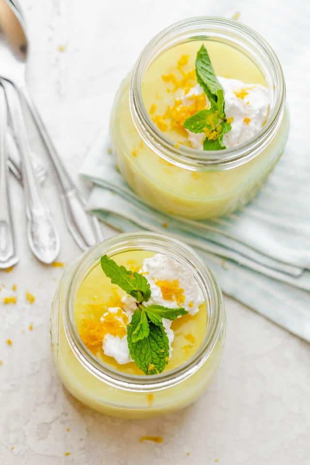 Vegan lemon pudding served with whipped coconut cream and fresh mint