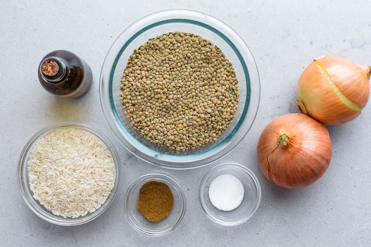 Ingredients for recipe before prepped: oil, rice, green lentils, ground cumin, salt, and 2 onions.