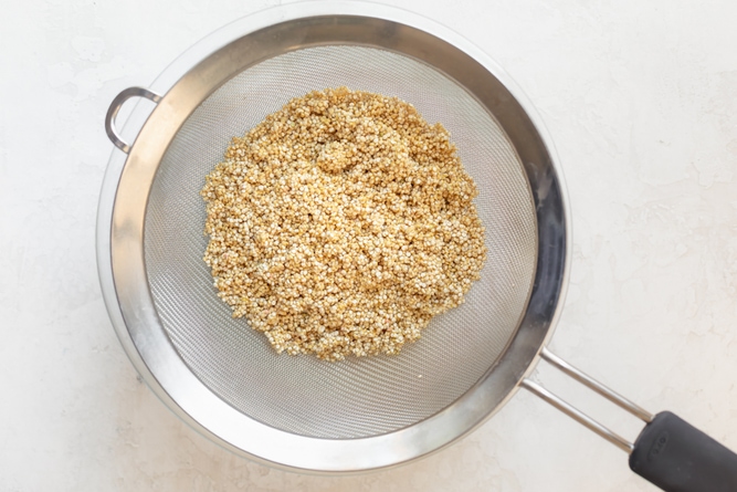 Rinsing and draining quinoa to make oatmeal